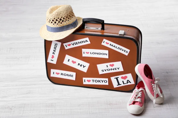 Suitcase with stickers on floor in room — Stock Photo, Image