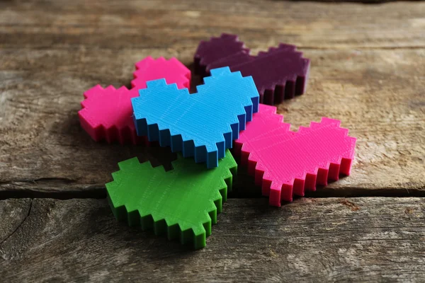 Plastic hearts on wooden background — Stock Photo, Image