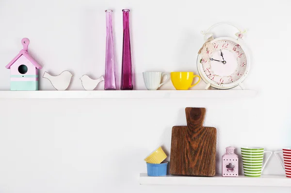 Kitchen utensils on wooden shelves — Stock Photo, Image