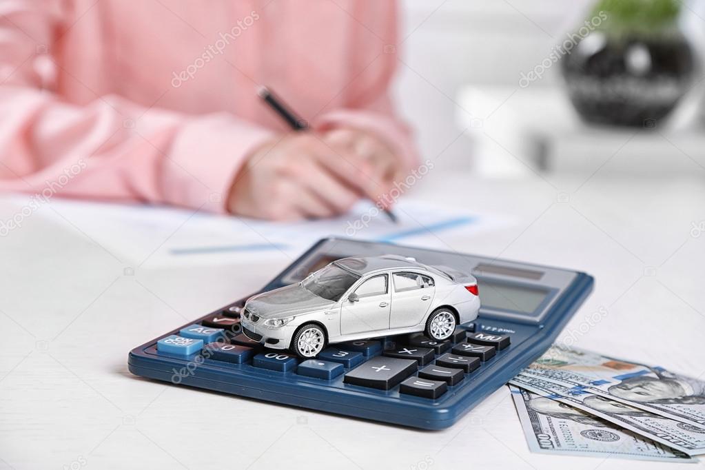 Toy car and documents on table. Car insurance concept