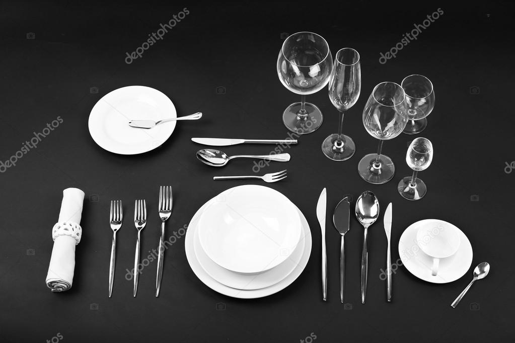 Table setting, close up, on black background