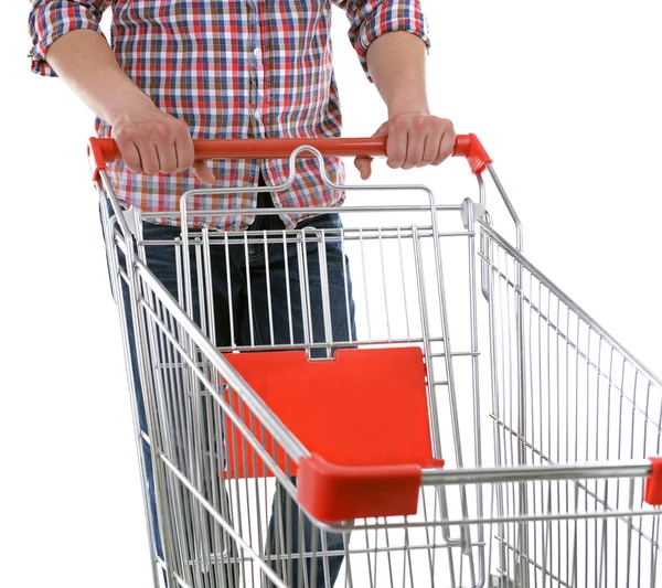 Young man with empty shopping cart isolated on white — Stock Photo, Image