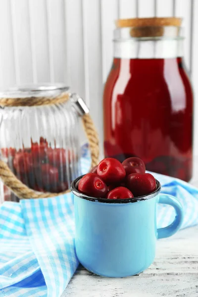 Sweet homemade cherry compote on table, on light background — Stock Photo, Image