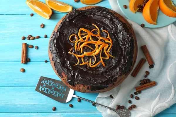 Cake with Chocolate Glaze and orange on color wooden background — Stock Photo, Image