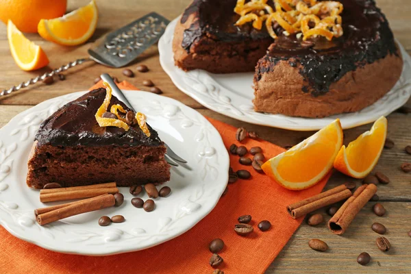 Cake with Chocolate Glaze and orange on plate, on wooden background — Stock Photo, Image