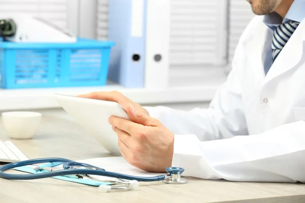 Doctor working at table in office — Stock Photo, Image