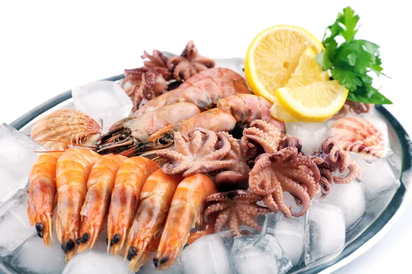 Seafood with lemon and ice on metal tray close up — Stock Photo, Image