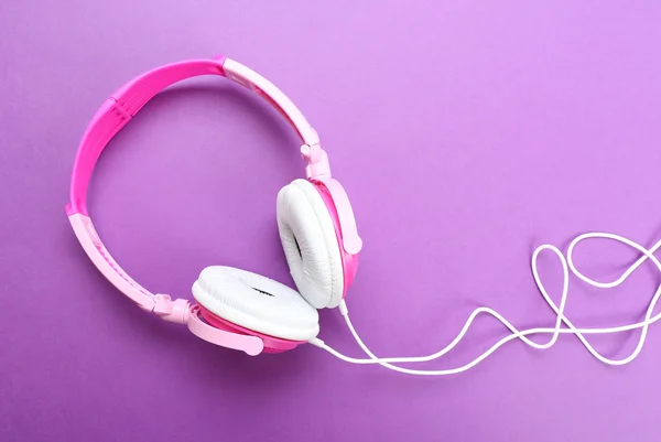 Pink headphones on purple — Stock Photo, Image