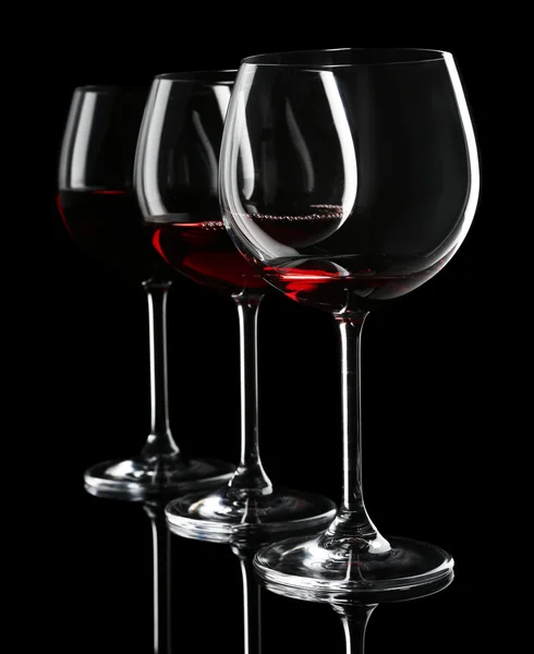 Glasses of wine on black — Stock Photo, Image