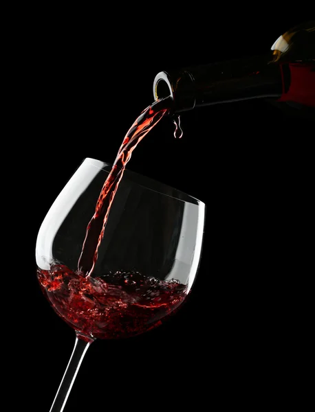 Red wine pouring into wine glass — Stock Photo, Image