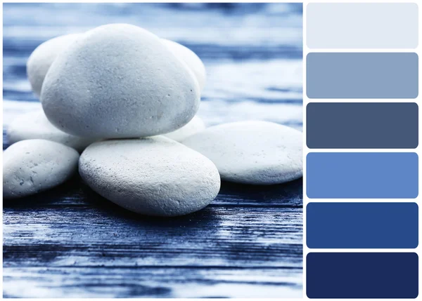 Wellness kameny na dřevěné pozadí a paletu barev. — Stock fotografie