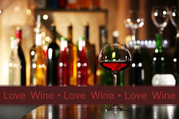 Glass of red wine in bar on blurred background — Stock Photo, Image