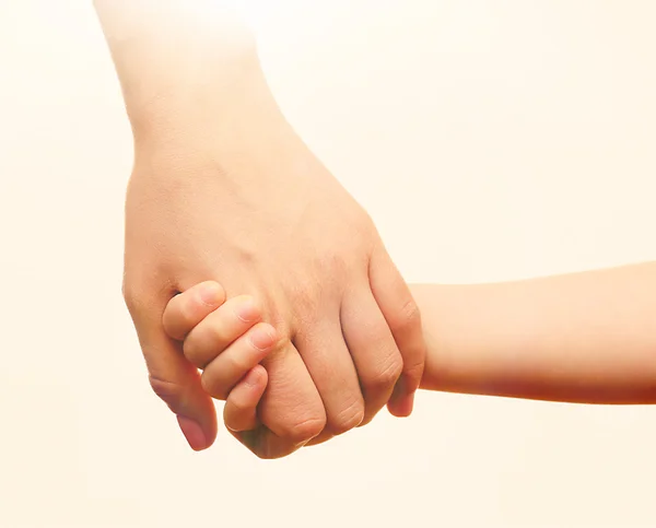 Child and mother hands together on light background — Stock Photo, Image