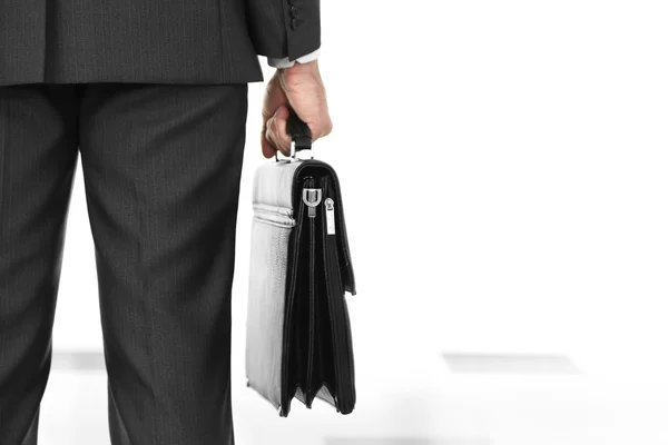 Man holding suitcase on light background — Stock Photo, Image