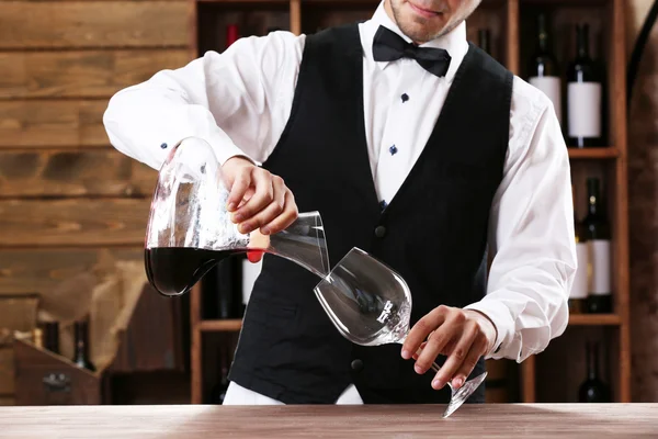 Bartender working at counter on bar background — Stock Photo, Image