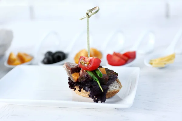 Tasty canapes on wooden table, close up — Stock Photo, Image