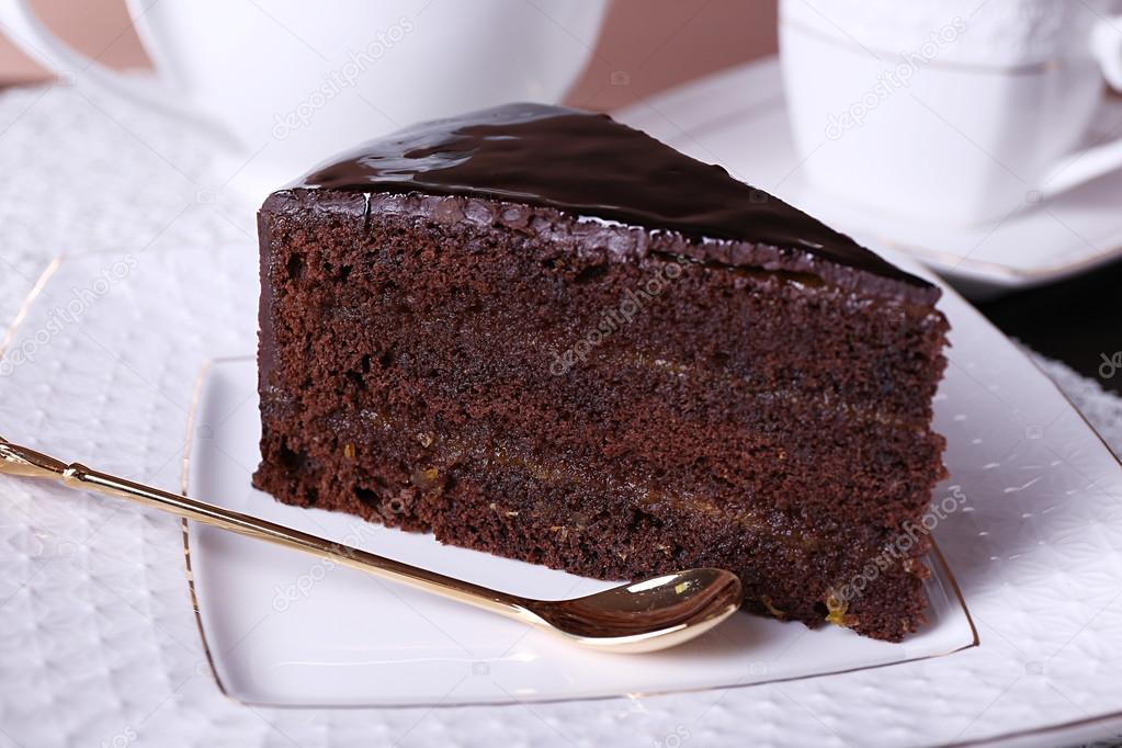 Piece of chocolate cake on white plate, closeup