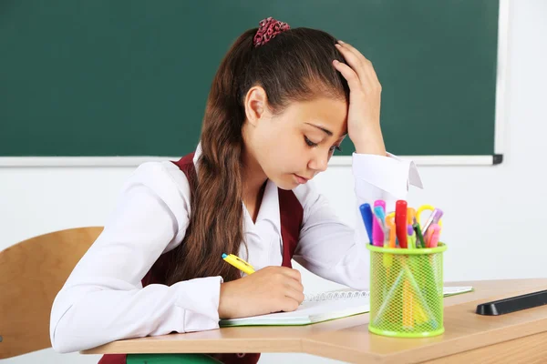 Hermosa colegiala en el aula cerca de pizarra —  Fotos de Stock