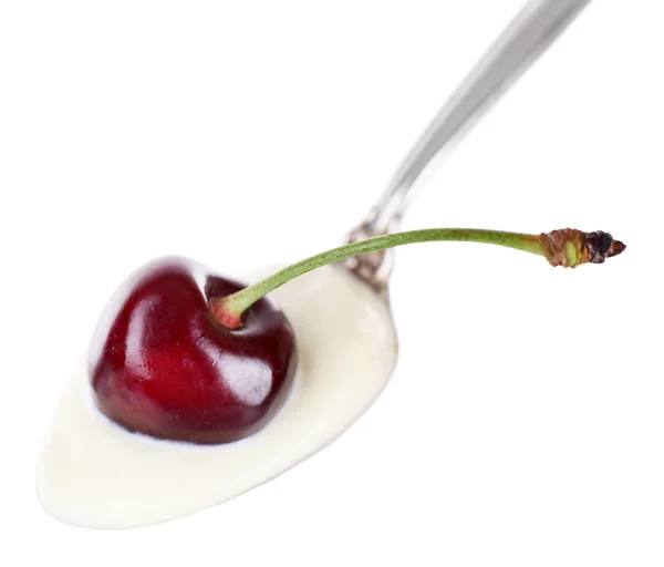 Delicious yogurt in spoon with cherry — Stock Photo, Image