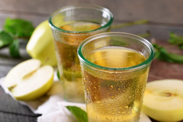 Vasos húmedos de jugo de manzana en la mesa de madera, primer plano —  Fotos de Stock