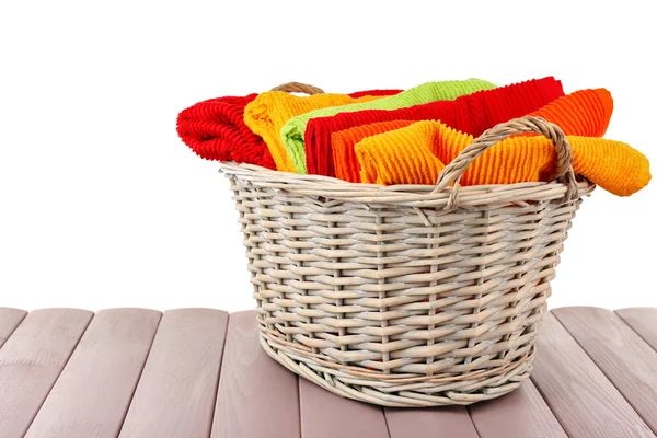 Colorful towels in basket isolated on white — Stock Photo, Image