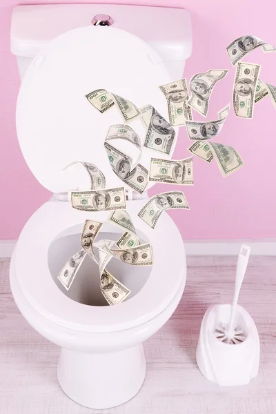 A lot of money is flushed down the toilet. — Stock Photo, Image