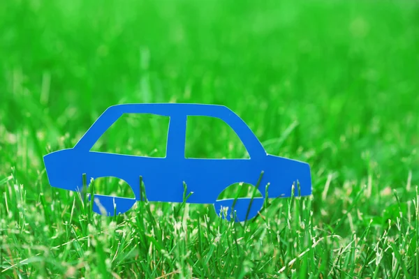 Cutout paper car over green grass — Stock Photo, Image