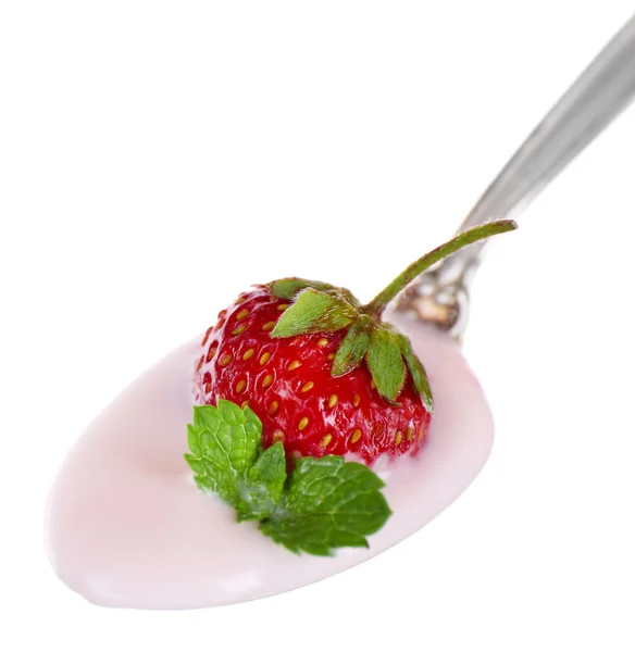 Delicious yogurt in spoon with strawberry and mint — Stock Photo, Image