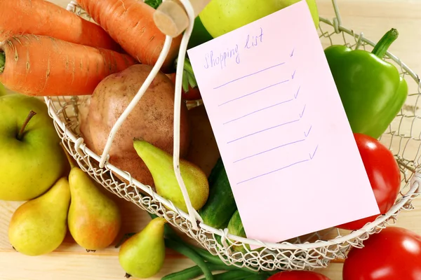 Fruits and vegetables with shopping list — Stock Photo, Image