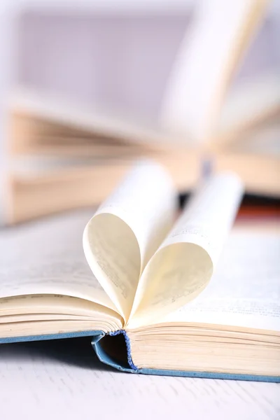 Pages of book curved into heart — Stock Photo, Image