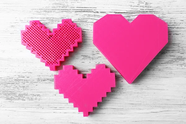 Plastic hearts on wooden background — Stock Photo, Image