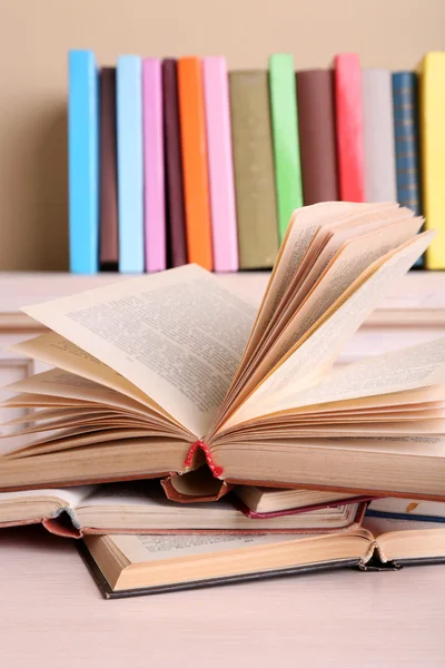 Opened books lying on bookshelf — Stock Photo, Image