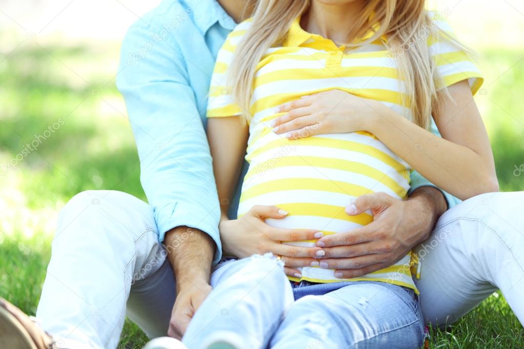 pregnant woman with husband in park