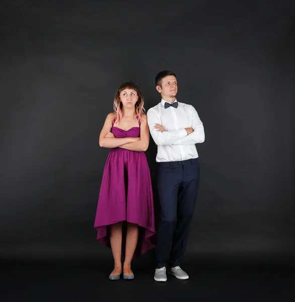 Young couple on black background — Stock Photo, Image