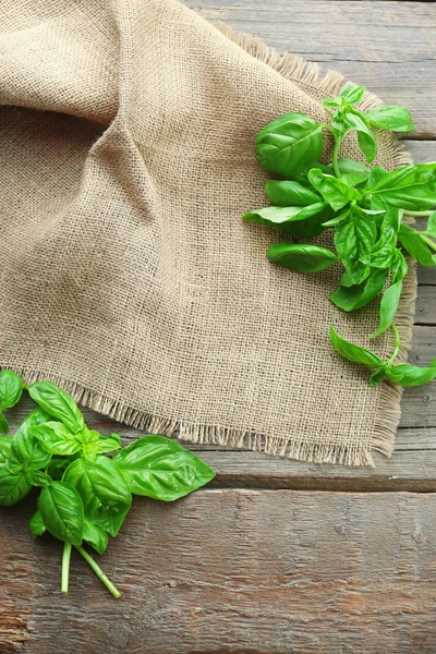 Green fresh basil with sackcloth on table close up — Stock Photo, Image