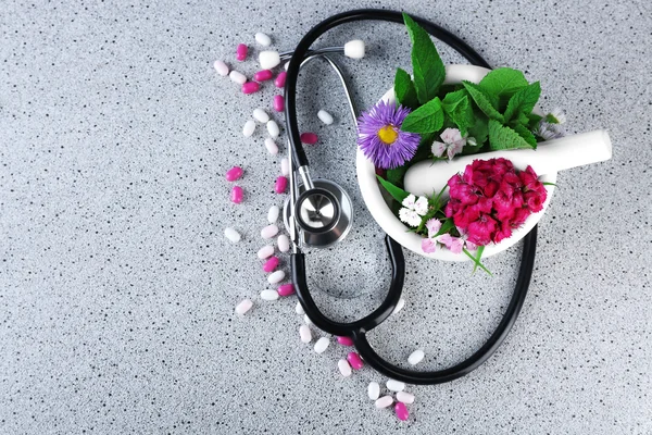 Alternative medicine herbs and stethoscope on wooden table background — Stock Photo, Image