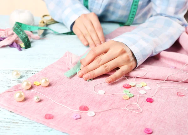 Mãos fechadas de costureira no trabalho com tecido de tecido — Fotografia de Stock