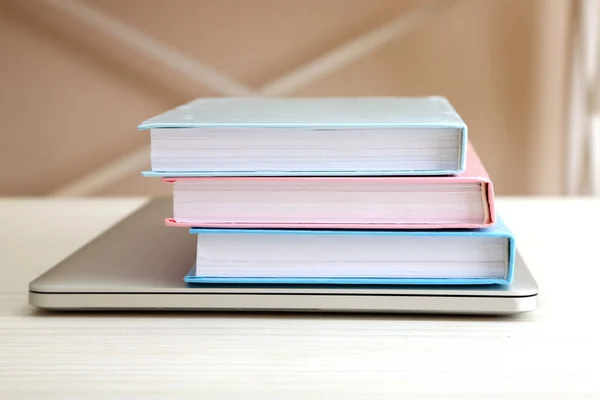 Stack of books with laptop on table close up — Stock Photo, Image