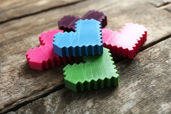 Plastic hearts on wooden background — Stock Photo, Image