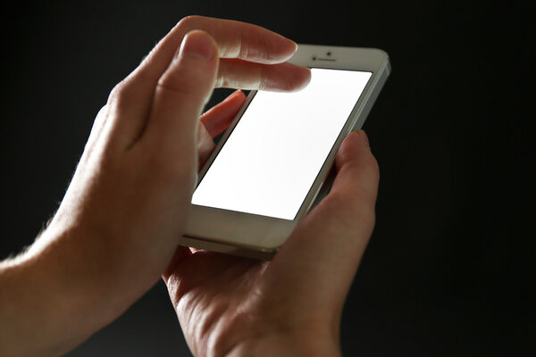 Finger touch number on smartphone to make a call on black background