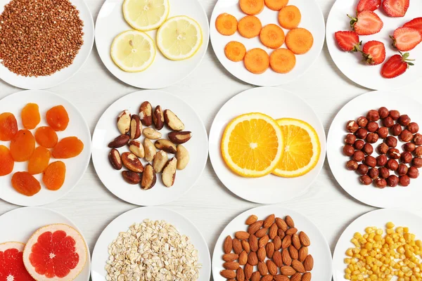 Set of orange products on wooden table, closeup — Stock Photo, Image