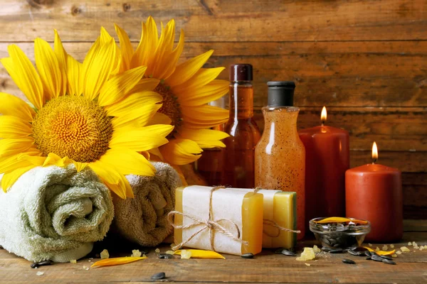 Spa treatments and sunflower on wooden background — Stock Photo, Image