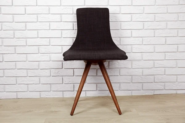 Modern chair on brick wall — Stock Photo, Image