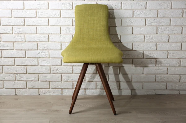 Modern chair on brick wall — Stock Photo, Image