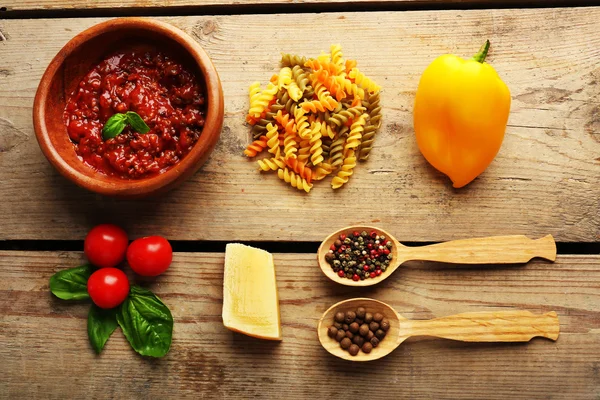 Pasta penne met tomaten, saus bolognese, kaas en basilicum op rustieke houten achtergrond — Stockfoto