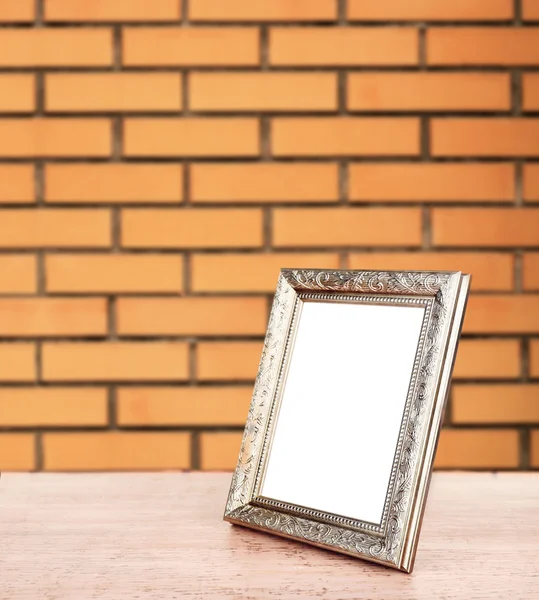 Old empty frame standing on table — Stock Photo, Image