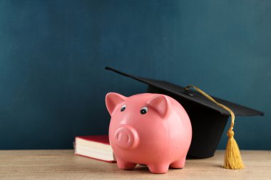Kitap ve grad şapka ile Piggy banka