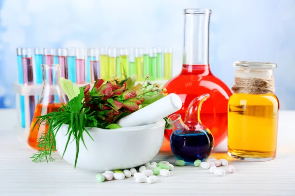 Herbs in mortar and test tubes — Stock Photo, Image