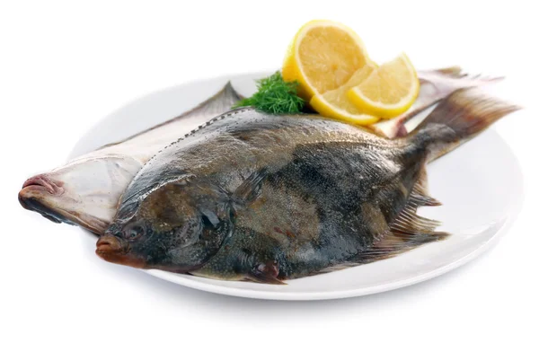 Färska fiskar med citron på tallrik — Stockfoto