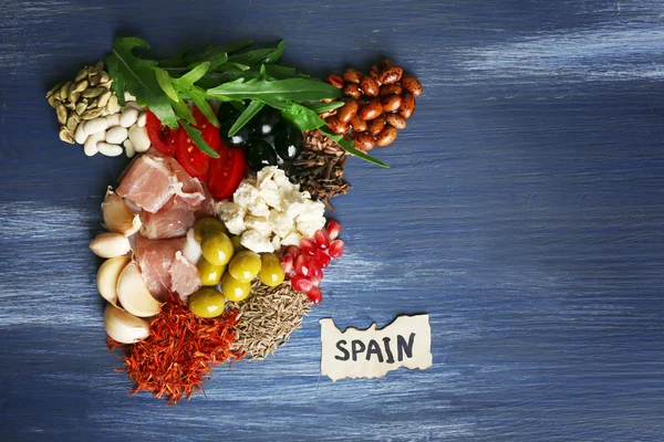 Map of Spain made with ingredients of traditional Spanish cuisine on color wooden background — Stock Photo, Image